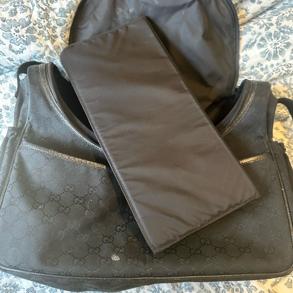 Black Gucci diaper bag. Changing pad never used